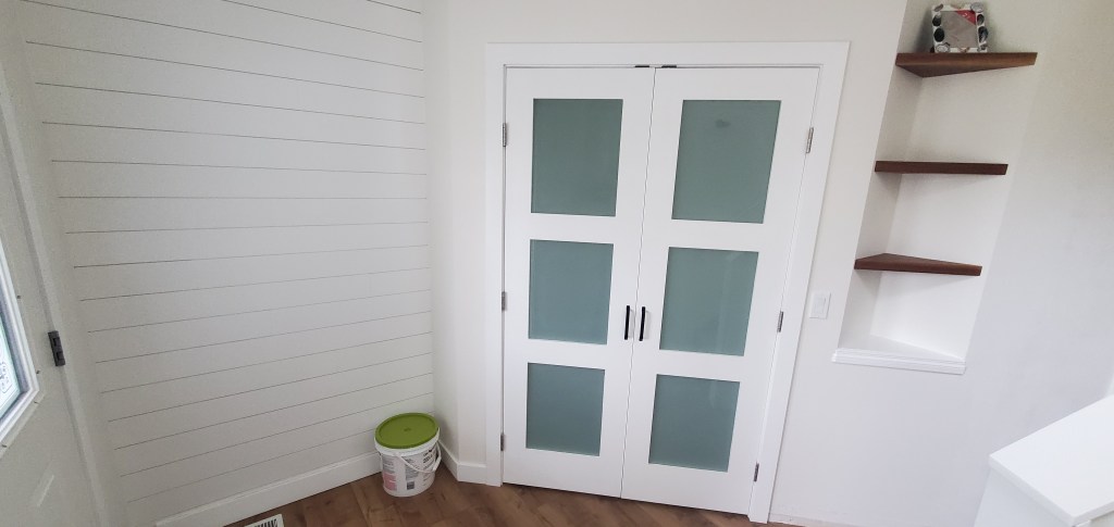 French doors, custom shelf and shiplap wall.